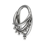 Anillo de piercing plateado con tres aros curvados y bolas sobre fondo blanco