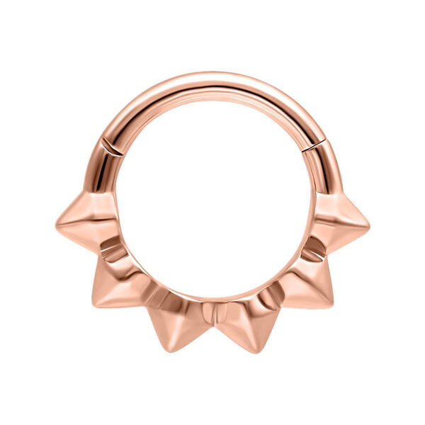 Anillo de piercing en oro rosado con púas sobre fondo blanco