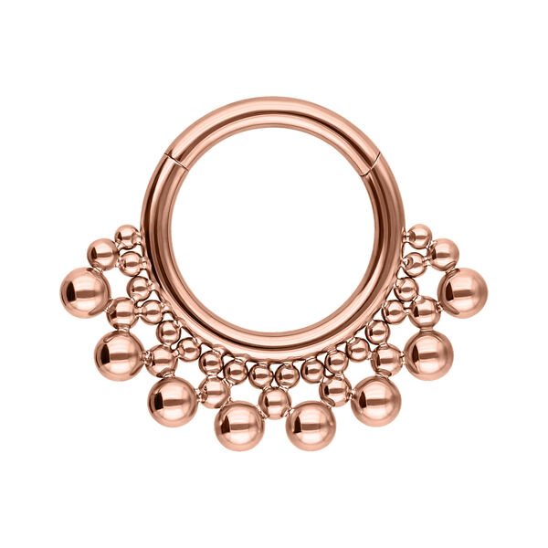 Septum Clicker de titanio rosado con diseño de bolas sobre fondo blanco
