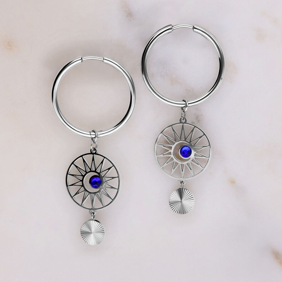 Orecchini a cerchio in argento con cristallo blu scuro su sfondo grigio chiaro