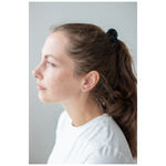 Mujer con pendientes de corazón de acero inoxidable, perfil lateral