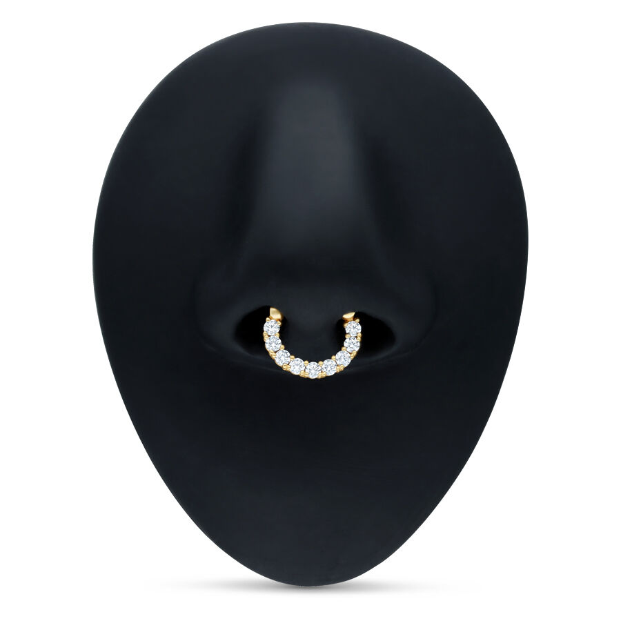 Clicker de septum dorado con cristales claros sobre fondo negro