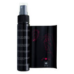 Flacone e confezione di spray per piercing nero su sfondo bianco