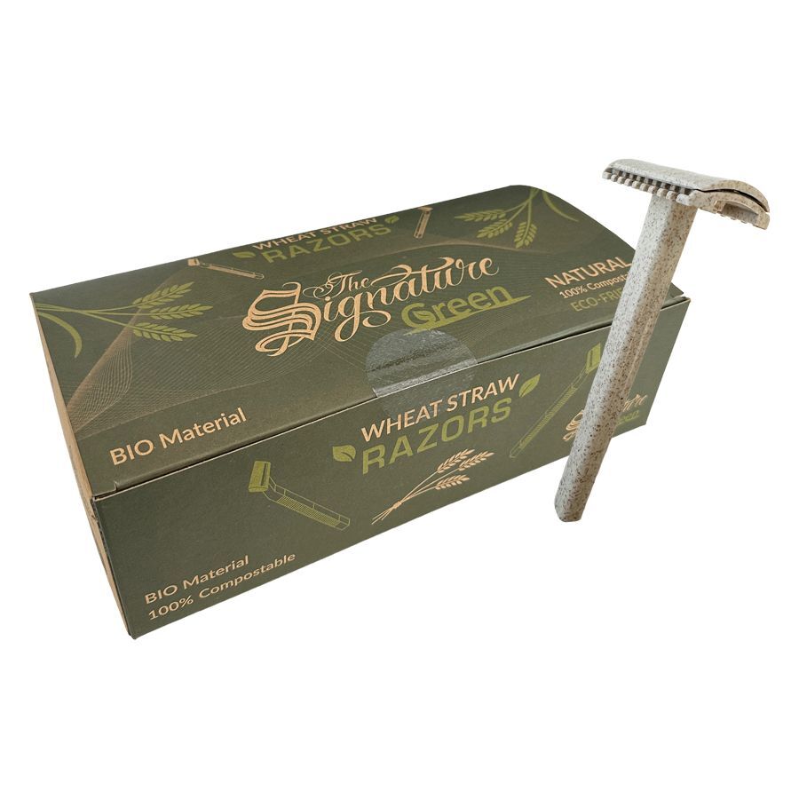 Rasoio usa e getta in paglia di grano accanto a una scatola verde con la scritta 'The Signature Green', su sfondo bianco