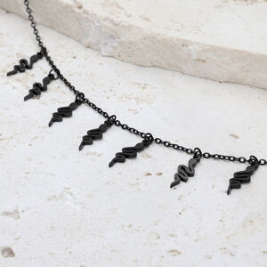 Schwarzes Snake Armband aus Chirurgenstahl Schwarzes Snake Armband mit verstellbarem Verschluss auf hellem Stein