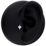 Accesorio Push Fit plateado con cristal turquesa sobre fondo negro