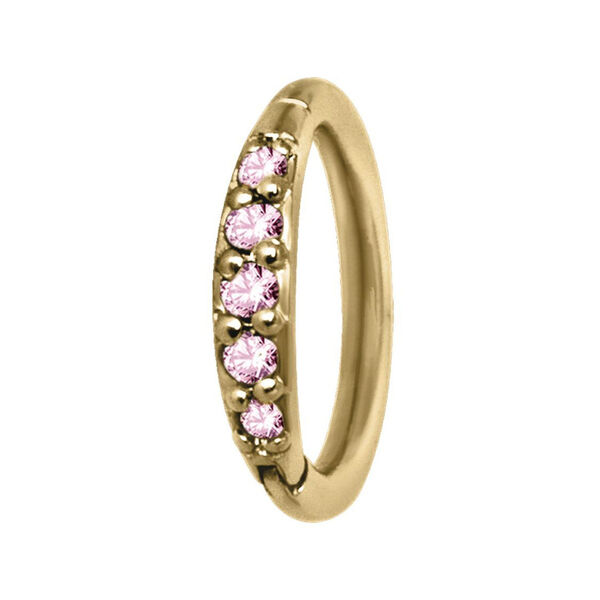 Anillo de piercing dorado con cristales rosas sobre fondo blanco