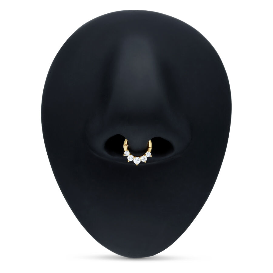 Clicker de septum dorado con cristales claros sobre fondo negro