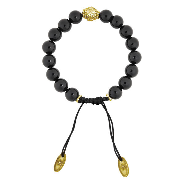 Pulsera de ónix negra con perla dorada y dos colgantes dorados sobre fondo blanco