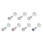 Seis Labrets Push-Fit con cristales de varios colores sobre fondo blanco