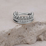 Silberner Triple Bubble Crystal Clicker auf hellem Stein